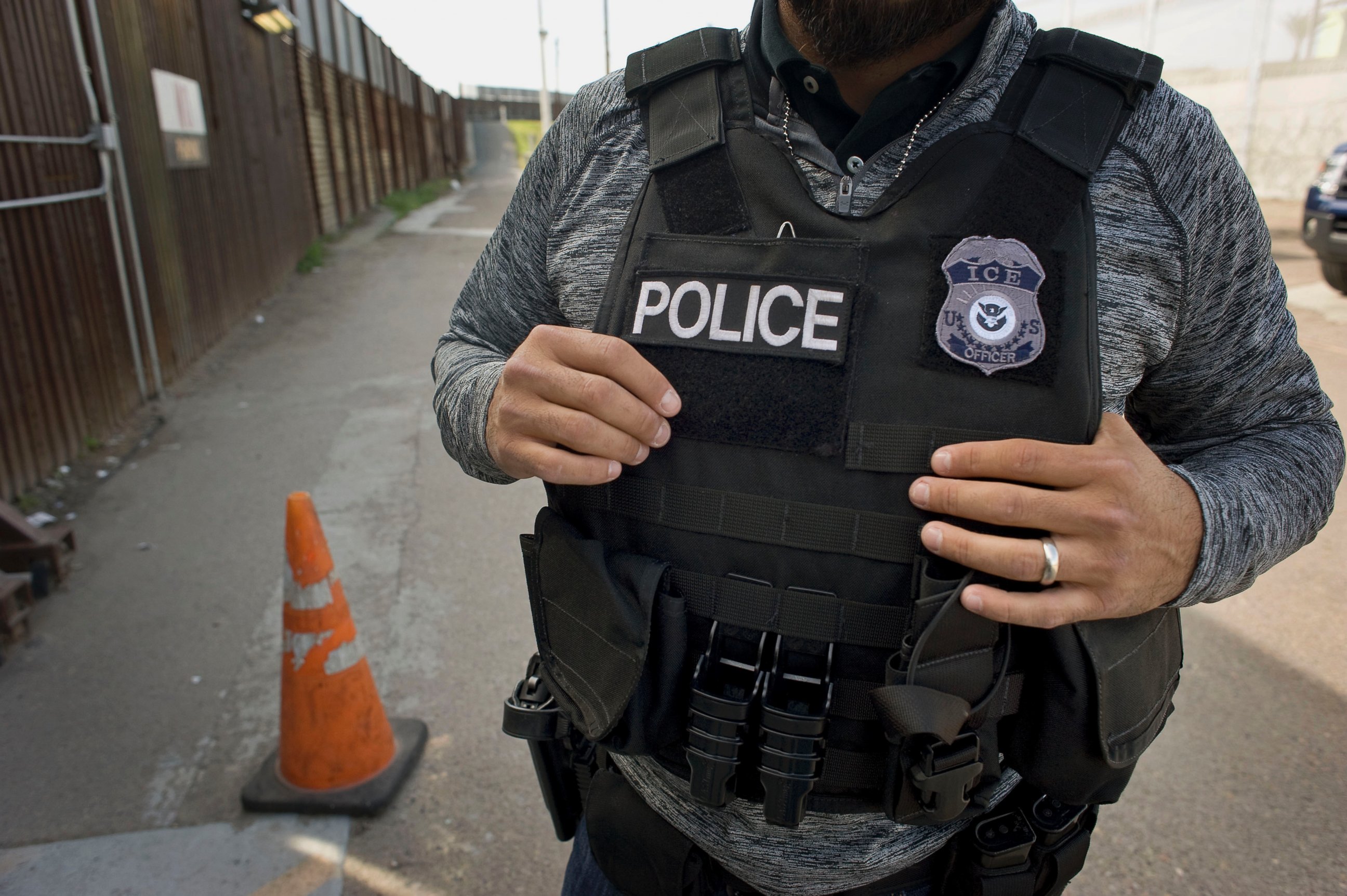 PHOTO: A U.S. Immigration and Customs Enforcement (ICE) agent waits as an undocumented man, not pictured, is deported to Mexico at the U.S. and Mexico border in San Diego, Calif., on Feb. 26, 2015. 