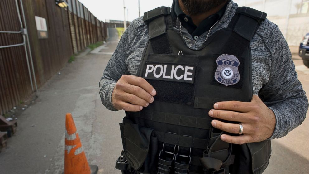 PHOTO: A U.S. Immigration and Customs Enforcement (ICE) agent waits as an undocumented man, not pictured, is deported to Mexico at the U.S. and Mexico border in San Diego, Calif., on Feb. 26, 2015. 