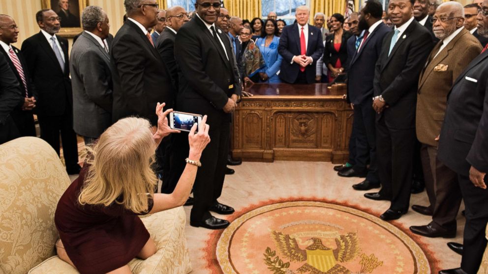 PHOTO: Counselor to the President, Kellyanne Conway, takes a photo as U.S. President Donald Trump and leaders of historically black universities and colleges talk before a group photo in the Oval Office of the White House, Feb. 27, 2017, in Washington.