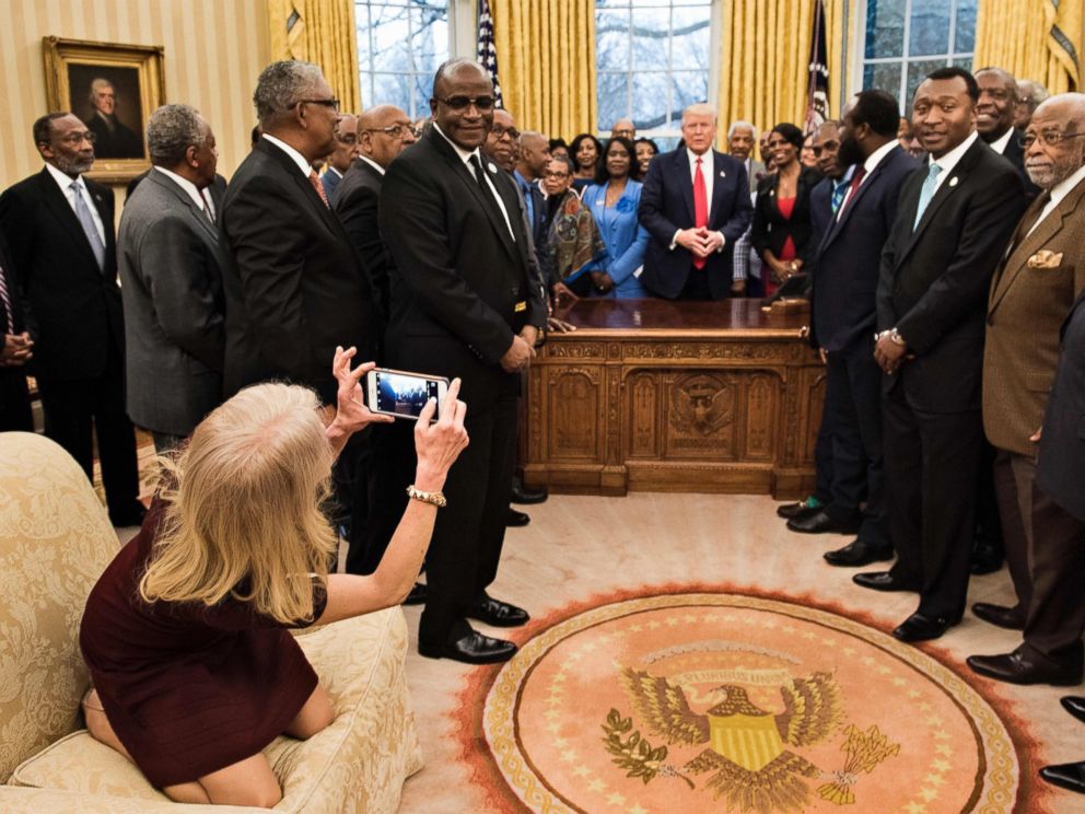PHOTO: Counselor to the President, Kellyanne Conway, takes a photo as U.S. President Donald Trump and leaders of historically black universities and colleges talk before a group photo in the Oval Office of the White House, Feb. 27, 2017, in Washington.