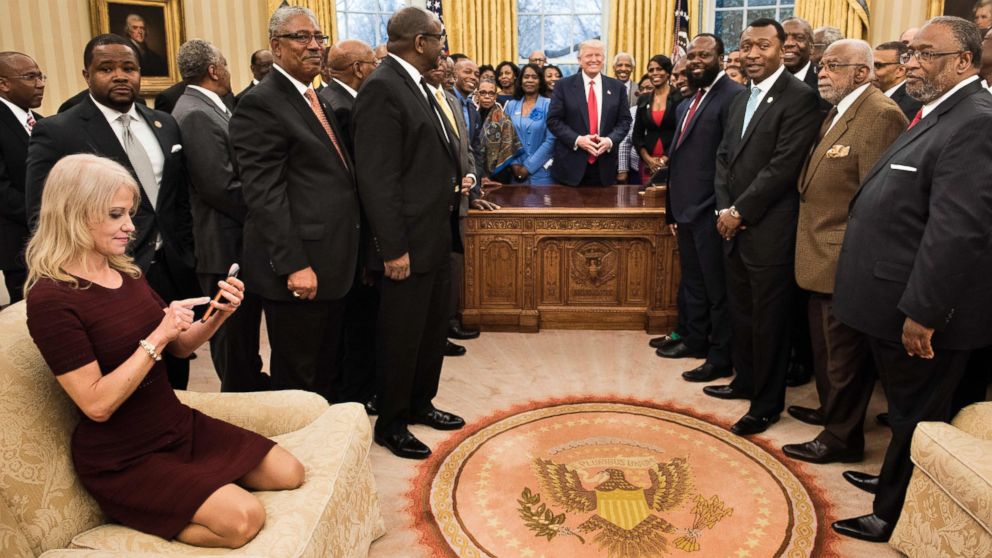 PHOTO: Counselor to the President Kellyanne Conway checks her phone after taking a photo as U.S. President Donald Trump and leaders of historically black universities and colleges pose for a group photo, Feb. 27, 2017, in Washington.