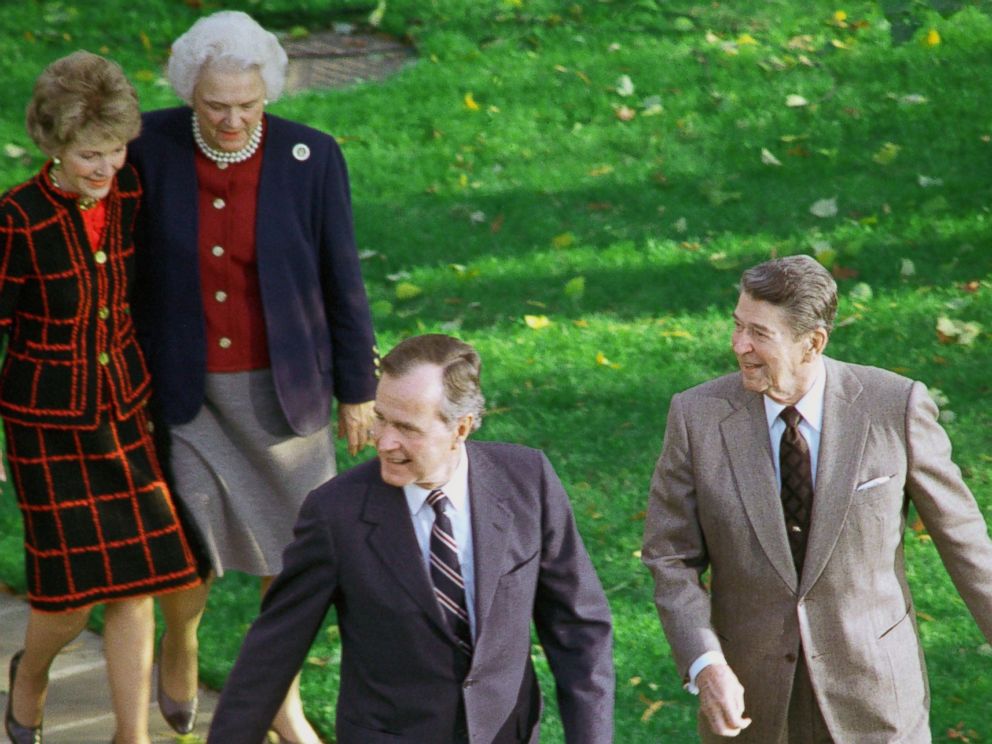 PHOTO: President Ronald Reagan with President-elect George Bush, accompanied by their wives, Barbara Bush and Nancy Reagan, as they headed for the Oval Office November 9, 1988 after Bushs arrival at the White House.