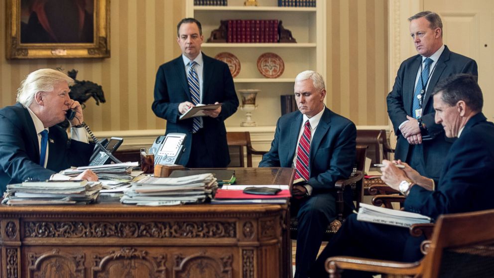 President Donald Trump surrounded by Reince Priebus, Vice President Mike Pence, Sean Spicer and National Security Adviser Michael Flynn, on the phone with Russian President Vladimir Putin, Jan. 28, 2017, in the Oval Office at the White House.