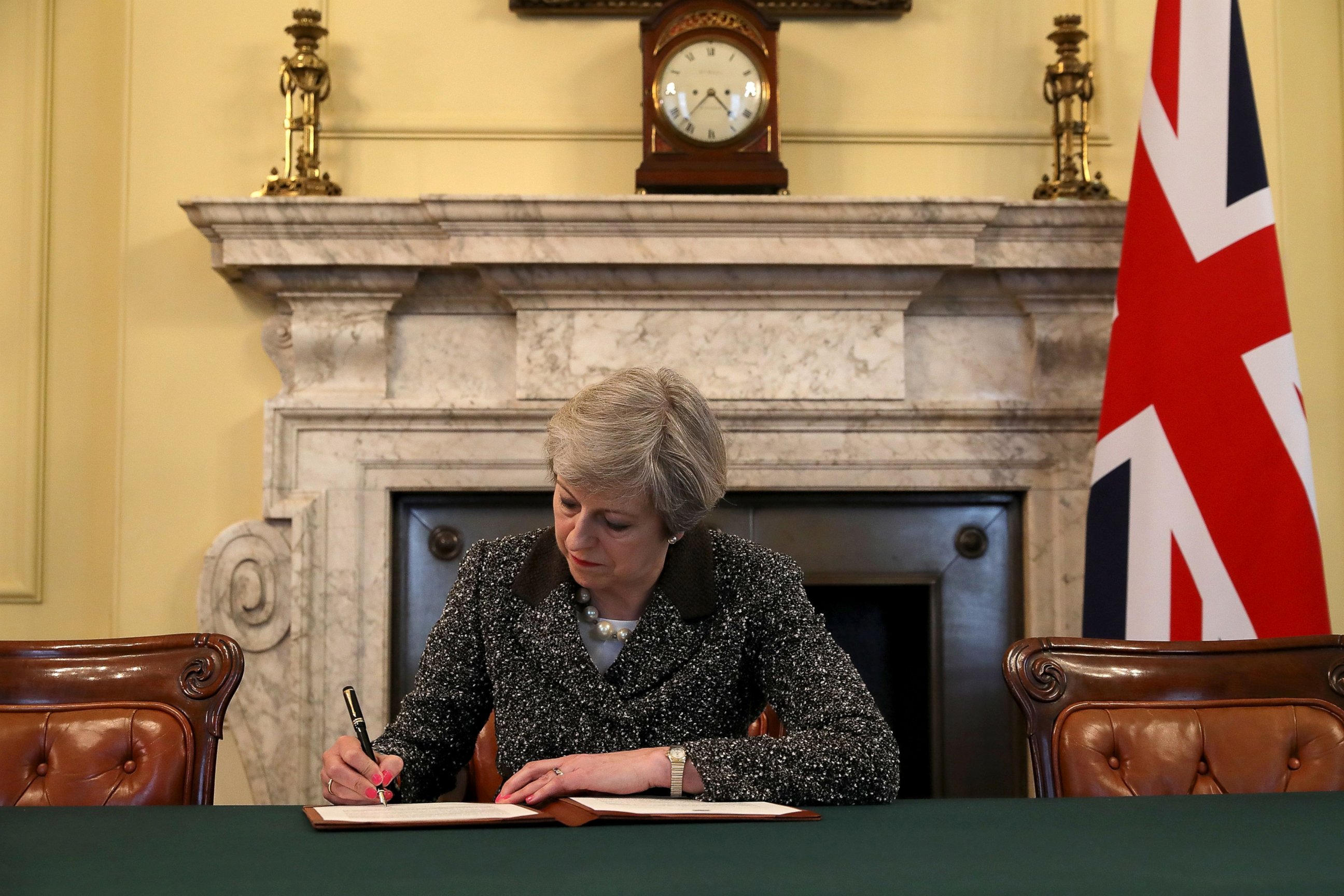 PHOTO: British Prime Minister Theresa May signs the official letter to European Council President Donald Tusk invoking Article 50 and the United Kingdom's intention to leave the EU, March 28, 2017 in London.