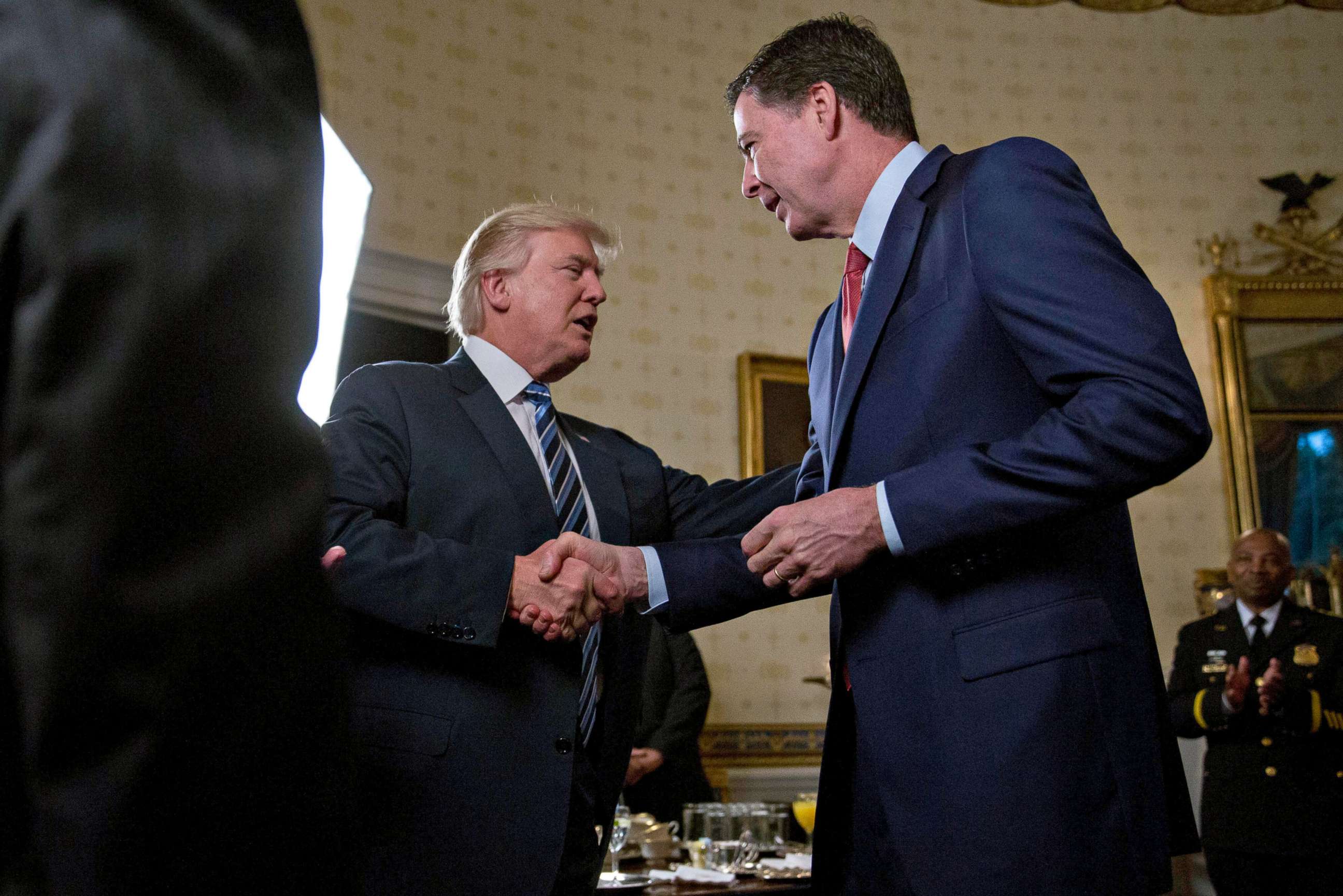 PHOTO: President Donald Trump shakes hands with James Comey, director of the Federal Bureau of Investigation (FBI), during an Inaugural Law Enforcement Officers and First Responders Reception at the White House, Jan. 22, 2017.