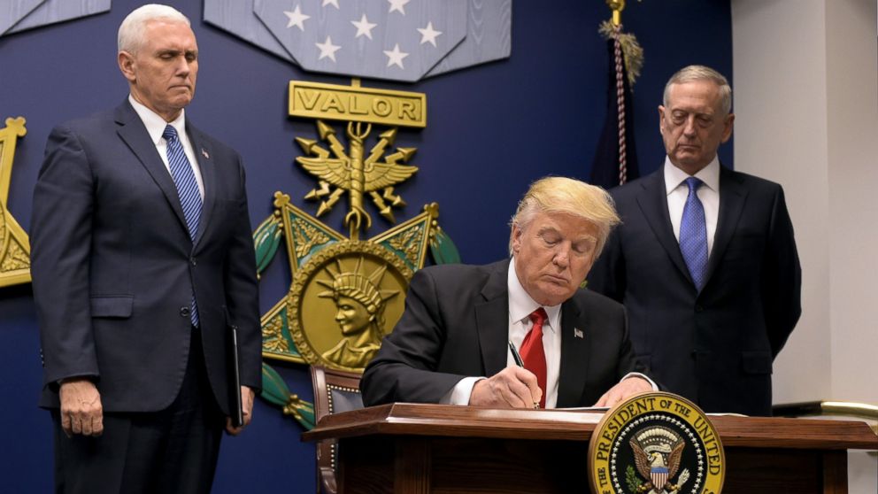 President Donald Trump signs an executive order alongside US Defense Secretary James Mattis and Vice President Mike Pence, Jan. 27, 2016 at the Pentagon in Washington.
