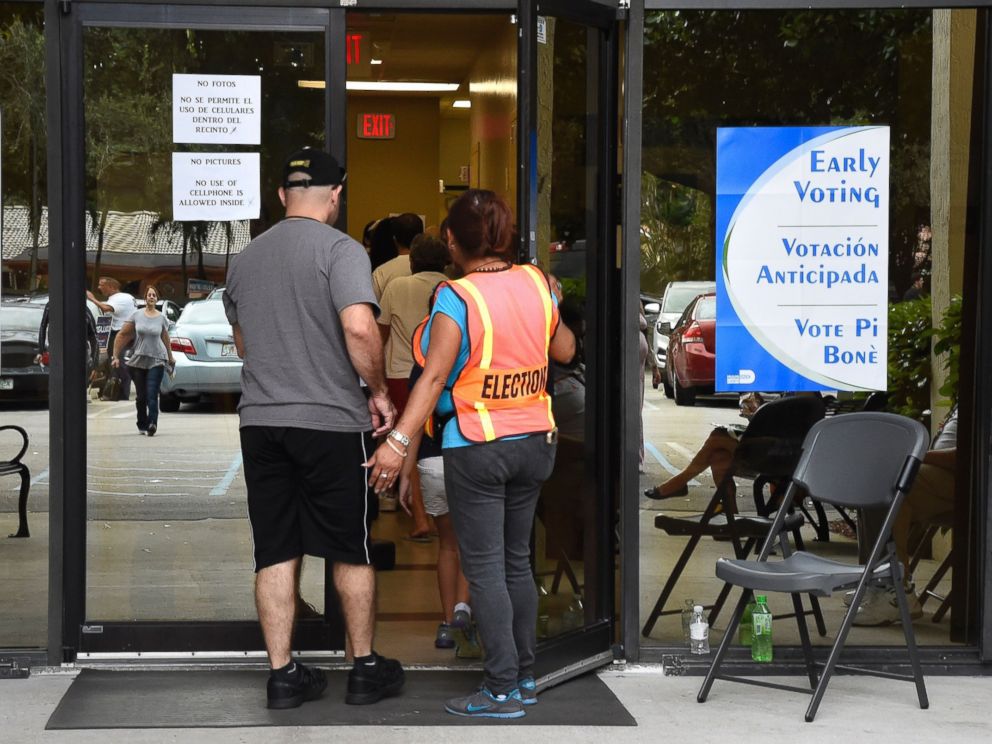PHOTO: People line up to vote at an early voting polling centre in Miami, Florida on Nov. 3, 2016.