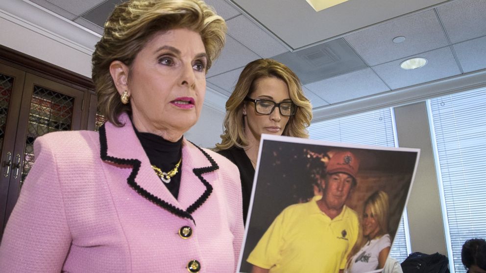 Attorney Gloria Allred holds a photo of Jessica Drake (R) with Donald Trump, taken in 2006 during an event where Drake alleges now-Republican presidential candidate Trump behaved in an sexually inappropriate way toward her, Oct. 22, 2016 in Los Angeles.