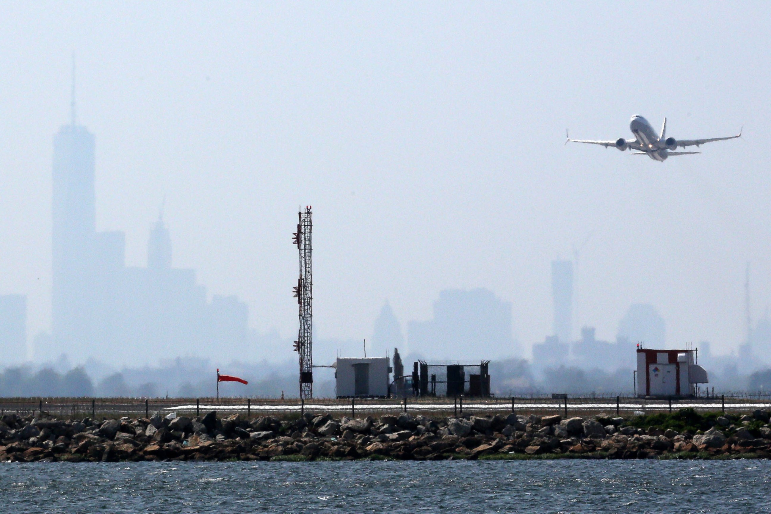 PHOTO: An aircraft takes off from New York's John F. Kennedy Airport against a hazy backdrop of the New York skyline, May 25, 2015. 