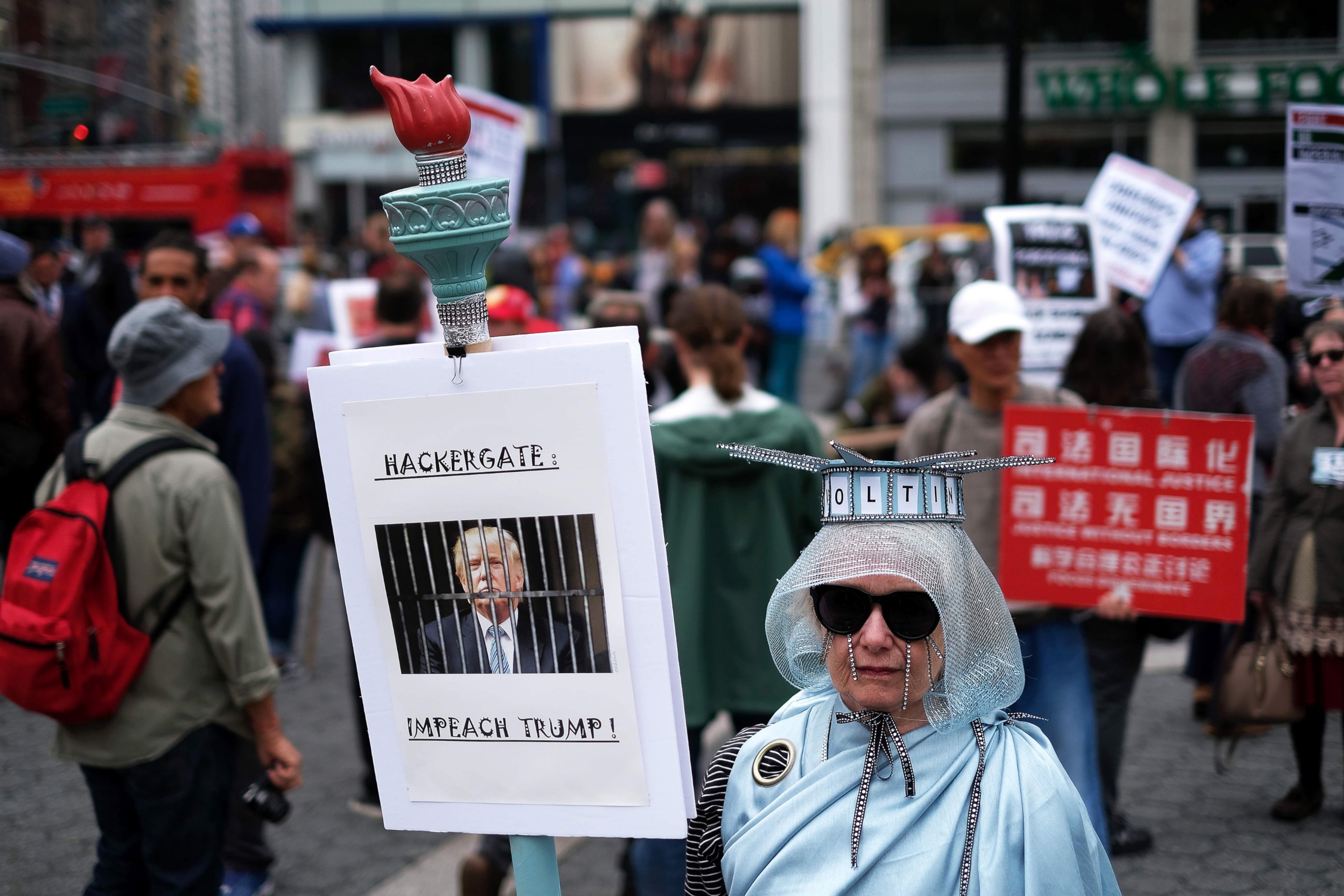 PHOTO: A protester displays a placard against President Donald Trump during a demonstration to mark May Day in New York, May 1, 2017.