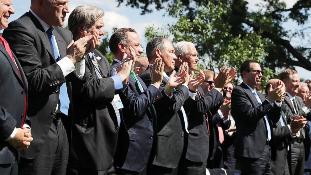 White House Chief Economic Adviser Gary Cohn, Chief Strategist Steve Bannon, Chief of Staff Reince Priebus, EPA Administrator Scott Pruitt, Vice President Mike Pence and Treasury Secretary Steve Mnuchin applaud as President Donald Trump announces his decision to withdraw the U.S. from the Paris climate agreement at the White House, June 1, 2017.