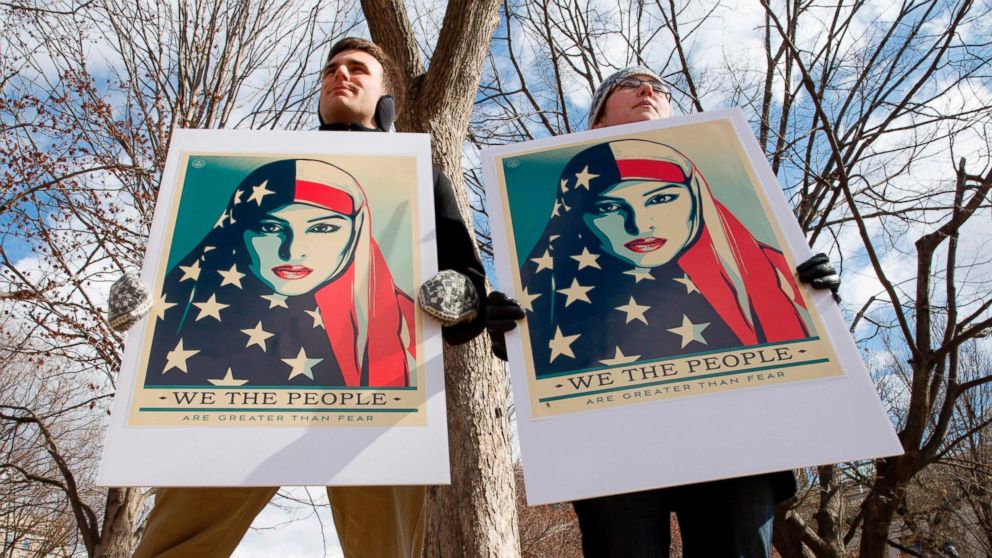 Demonstrators gather near The White House to protest President Donald Trump's travel ban, March 11, 2017, in Washington.