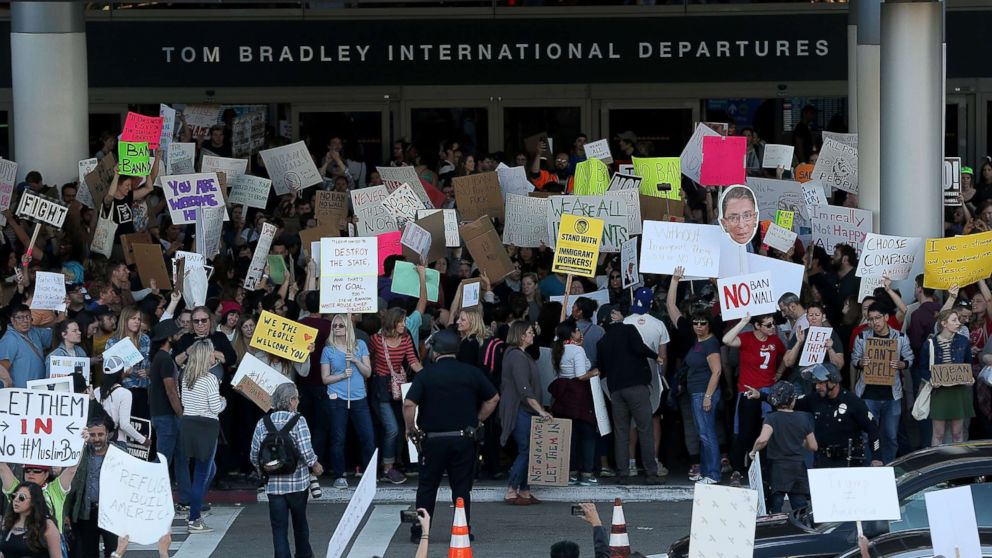PHOTO: Protesters hold signs during a demonstration against the immigration ban that was imposed by U.S. President Donald Trump at Los Angeles International Airport, Jan. 29, 2017.