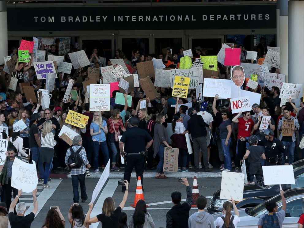 PHOTO: Protesters hold signs during a demonstration against the immigration ban that was imposed by U.S. President Donald Trump at Los Angeles International Airport, Jan. 29, 2017.