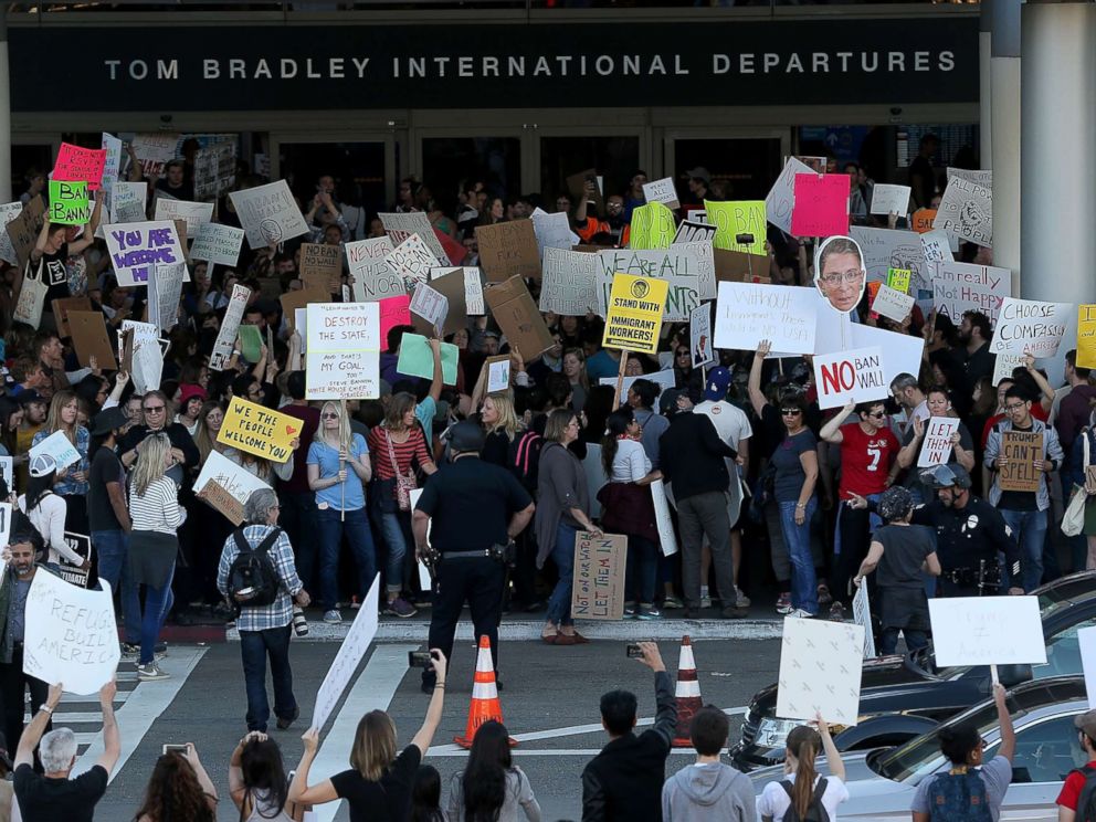 PHOTO: Protesters hold signs during a demonstration against the immigration ban at Los Angeles International Airport, Jan. 29, 2017.