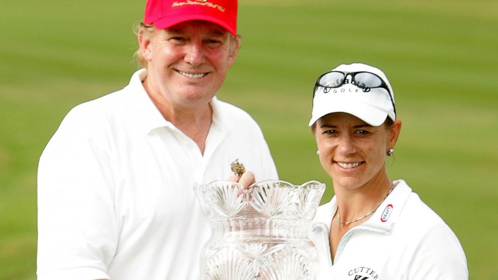 PHOTO: Annika Sorenstam of Sweden poses with Donald Trump and the trophy on the 18th green at the Trump International Golf Club, Nov. 21, 2004, in West Palm Beach, Florida. 