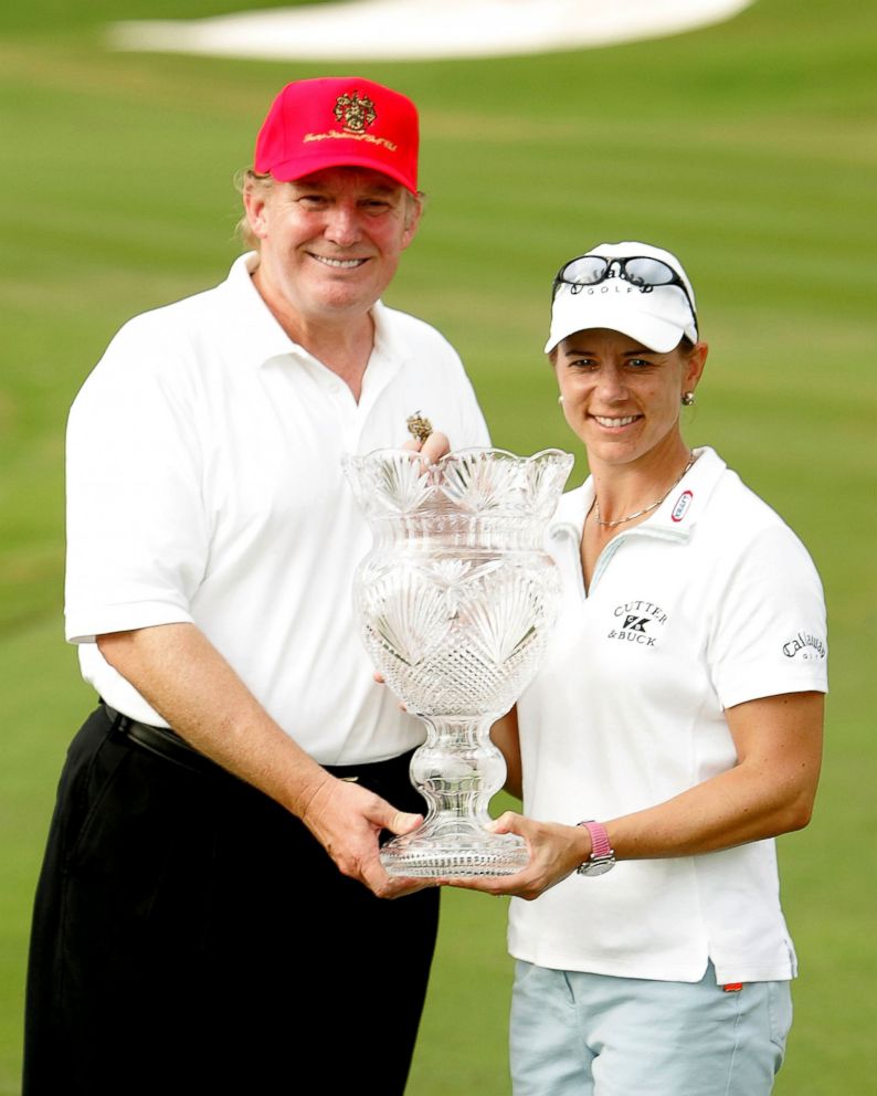 PHOTO: Annika Sorenstam of Sweden poses with Donald Trump and the trophy on the 18th green at the Trump International Golf Club, Nov. 21, 2004, in West Palm Beach, Florida. 