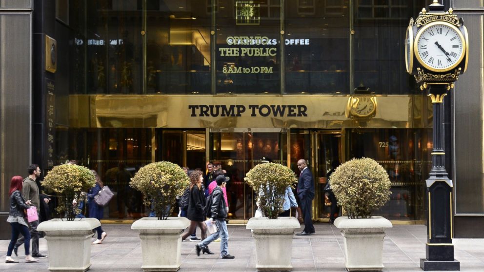 New York City shoppers and visitors walk past the entrance to Trump Tower on Fifth Avenue, a mixed use skyscraper owned by Donald Trump.