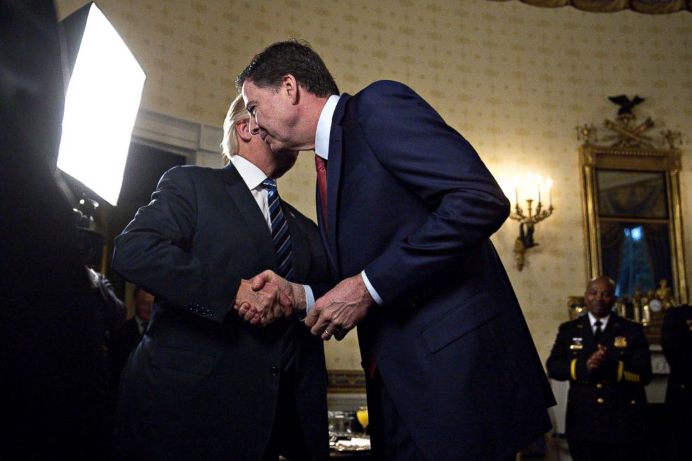 PHOTO: President Donald Trump, left, shakes hands with James Comey, director of the Federal Bureau of Investigation, during an Inaugural Law Enforcement Officers and First Responders Reception at the White House in Washington, Jan. 22, 2017.