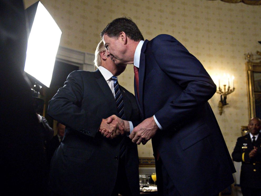 PHOTO: President Donald Trump, left, shakes hands with James Comey, director of the Federal Bureau of Investigation, during an Inaugural Law Enforcement Officers and First Responders Reception at the White House in Washington, Jan. 22, 2017.