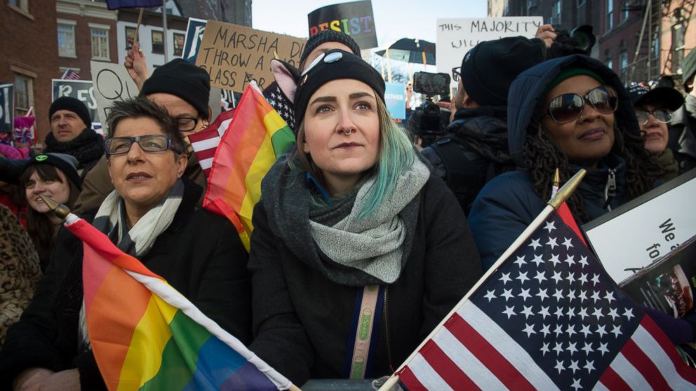 PHOTO: People hold signs and flags at a rally in front of the Stonewall Inn in solidarity with immigrants, asylum seekers, refugees, and the LGBT, Feb. 4, 2017 in New York.