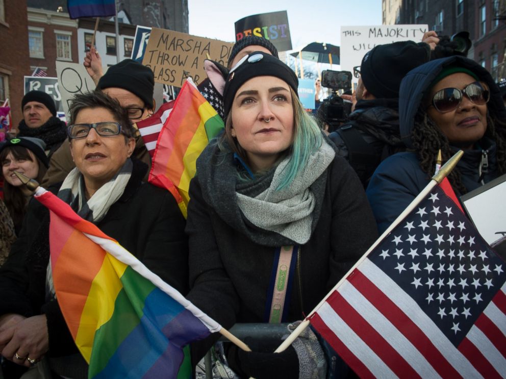 PHOTO: People hold signs and flags at a rally in front of the Stonewall Inn in solidarity with immigrants, asylum seekers, refugees, and the LGBT, Feb. 4, 2017 in New York.