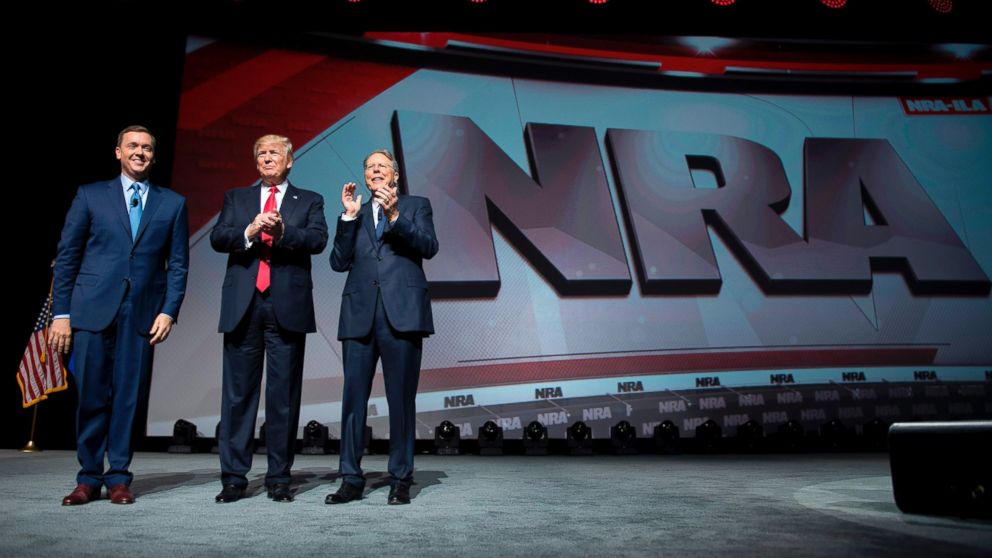 PHOTO: Donald Trump stands with National Rifle Association (NRA) President Wayne LaPierre, right, and NRA-ILA Executive Director Chris Cox during the NRA Leadership Forum in Atlanta, Georgia, April 28, 2017. 