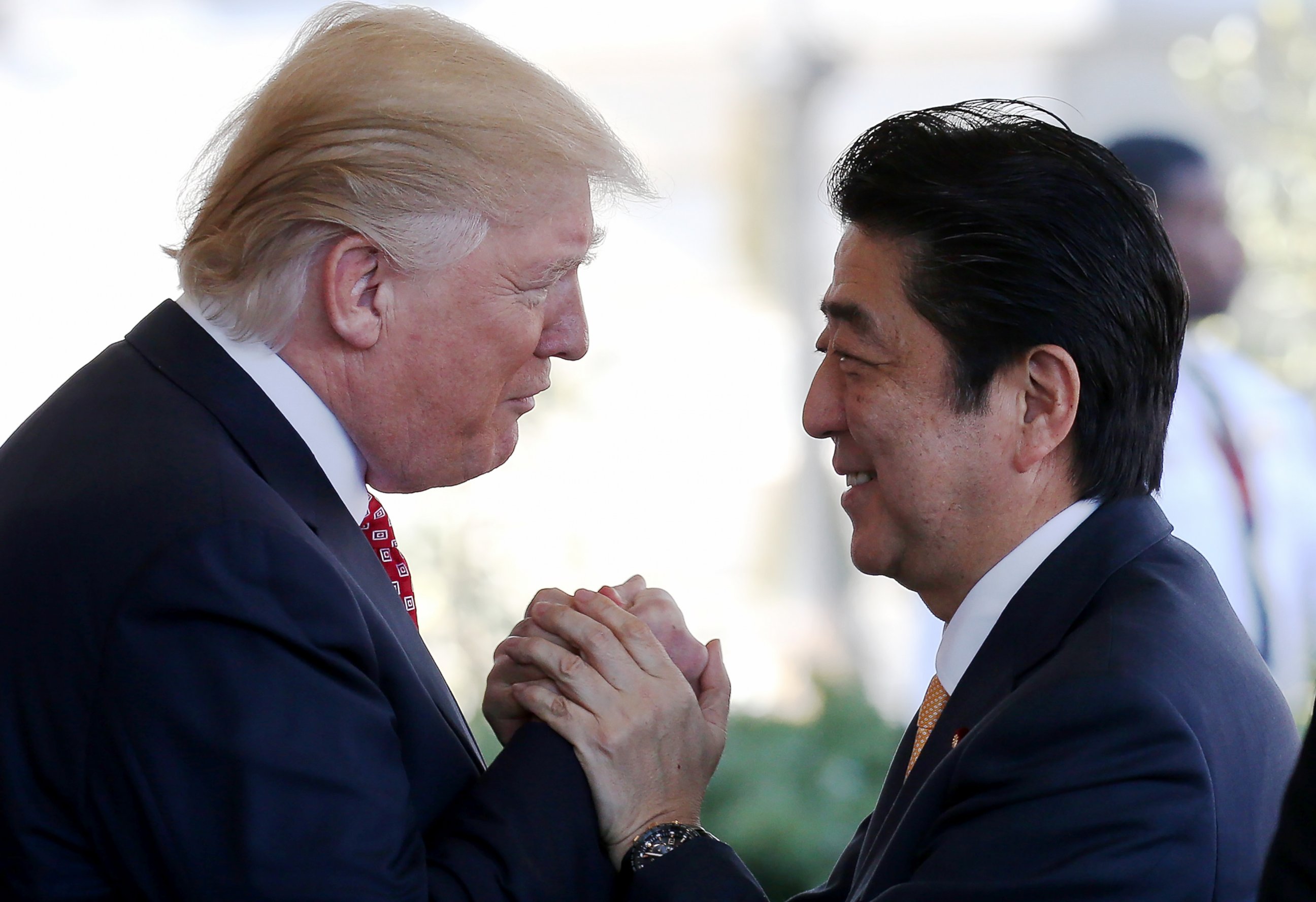 PHOTO: President Donald Trump greets Japanese Prime Minister Shinzo Abe as he arrives at the White House, Feb. 10, 2017, in Washington. 