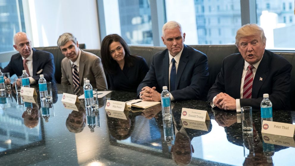 Jeff Bezos, chief executive officer of Amazon, Larry Page, chief executive officer of Alphabet Inc. (parent company of Google), Sheryl Sandberg, chief operating officer of Facebook, Vice President-elect Mike Pence listen as President-elect Donald Trump speaks during a meeting of technology executives at Trump Tower, Dec. 14, 2016, in New York City. 