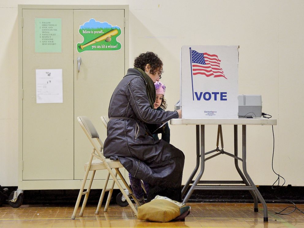 PHOTO: Willa Domina, 6, watches her mother, Emily Katz, vote at a polling station, Nov. 8, 2016, in Durham, North Carolina.