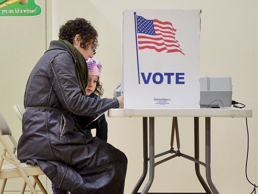PHOTO: Willa Domina, 6, watches her mother, Emily Katz, vote at a polling station, Nov. 8, 2016, in Durham, North Carolina. 