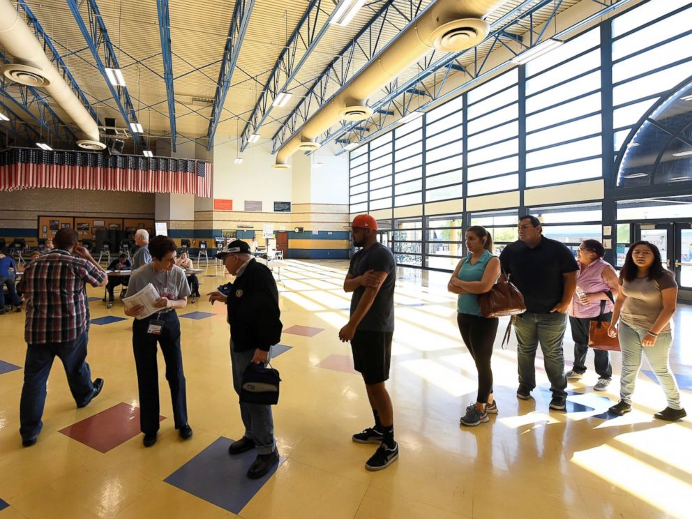 PHOTO: Voters are greeted at Cheyenne High School as they arrive to cast their ballots on Election Day, Nov. 8, 2016, in North Las Vegas, Nevada.