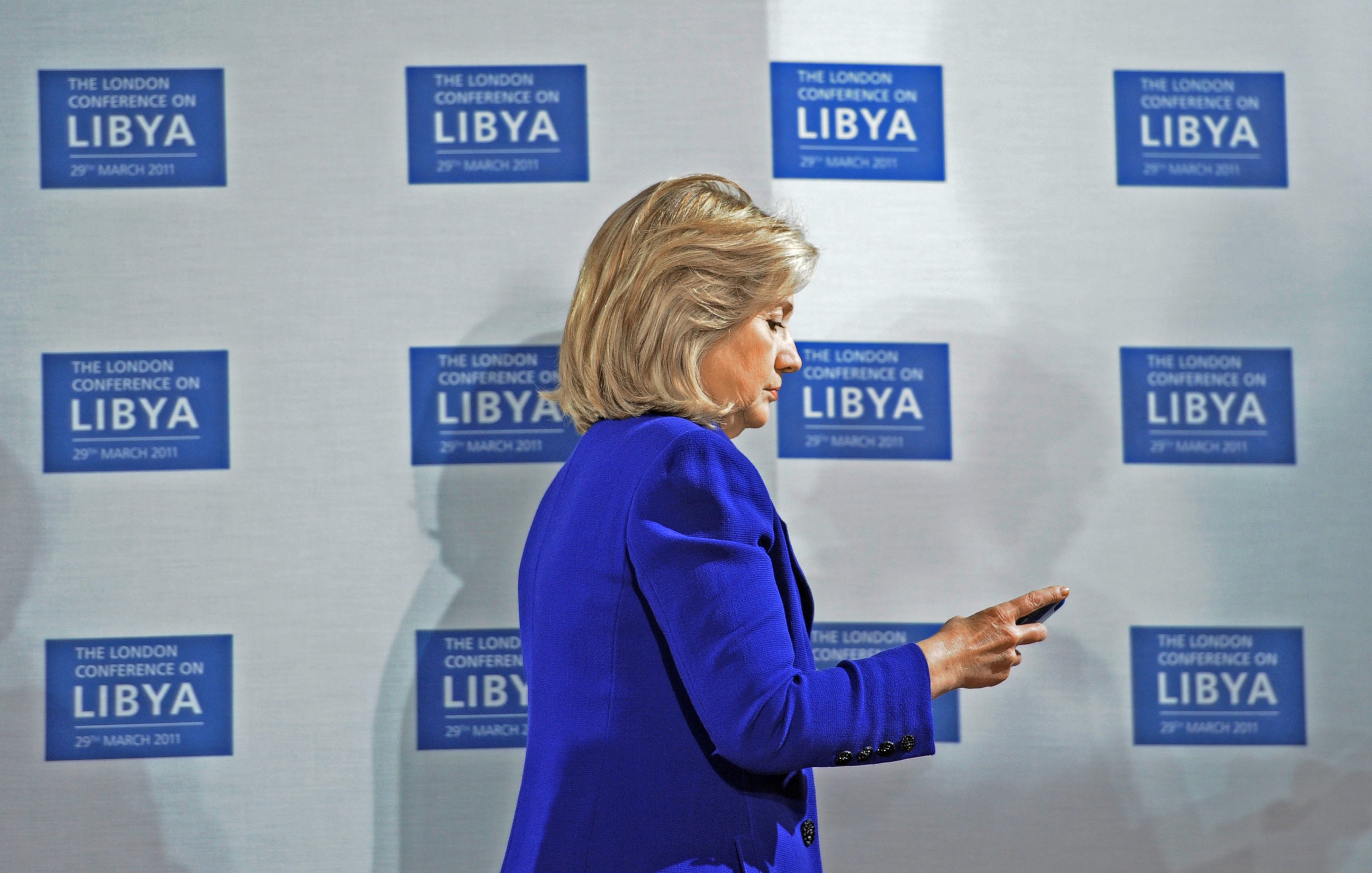 PHOTO: U.S. Secretary of State Hillary Clinton checks her phone at the opening of the Libyan Conference, a meeting of international allies to discuss the next steps for Libya, on March 29, 2011, in London.