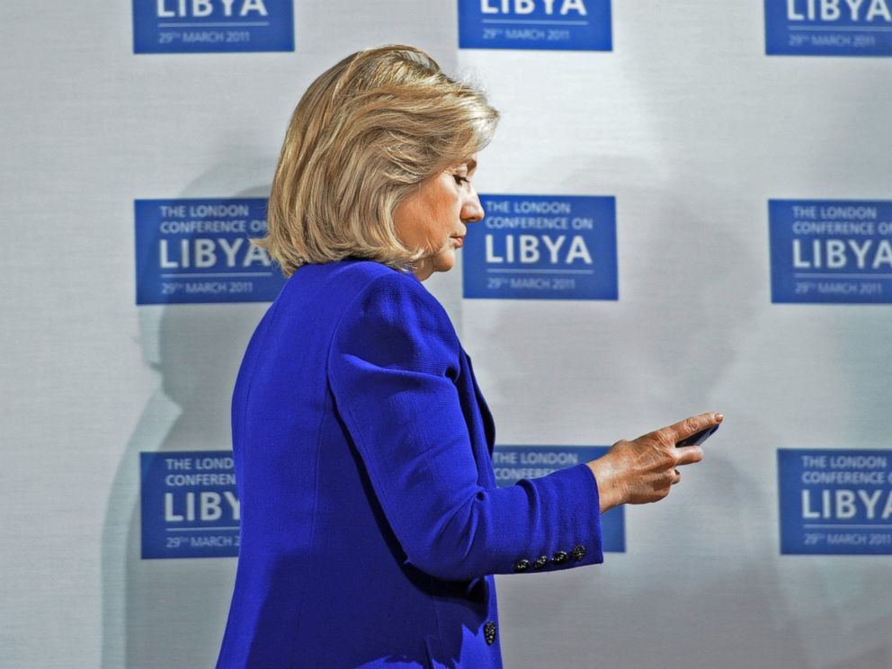 PHOTO: U.S. Secretary of State Hillary Clinton checks her phone at the opening of the Libyan Conference, a meeting of international allies to discuss the next steps for Libya, on March 29, 2011, in London.