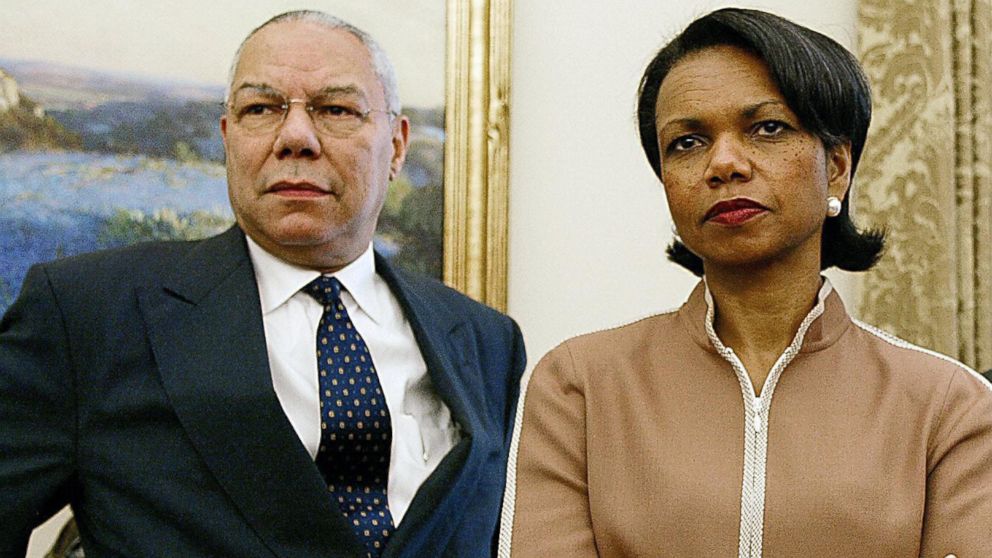 US Secretary of State Colin Powell and National Security Advisor Condoleezza Rice look on as US President George W. Bush meets with Chilean President Ricardo Lagos in the Oval Office of the White House 19 July 2004 in Washington, DC.