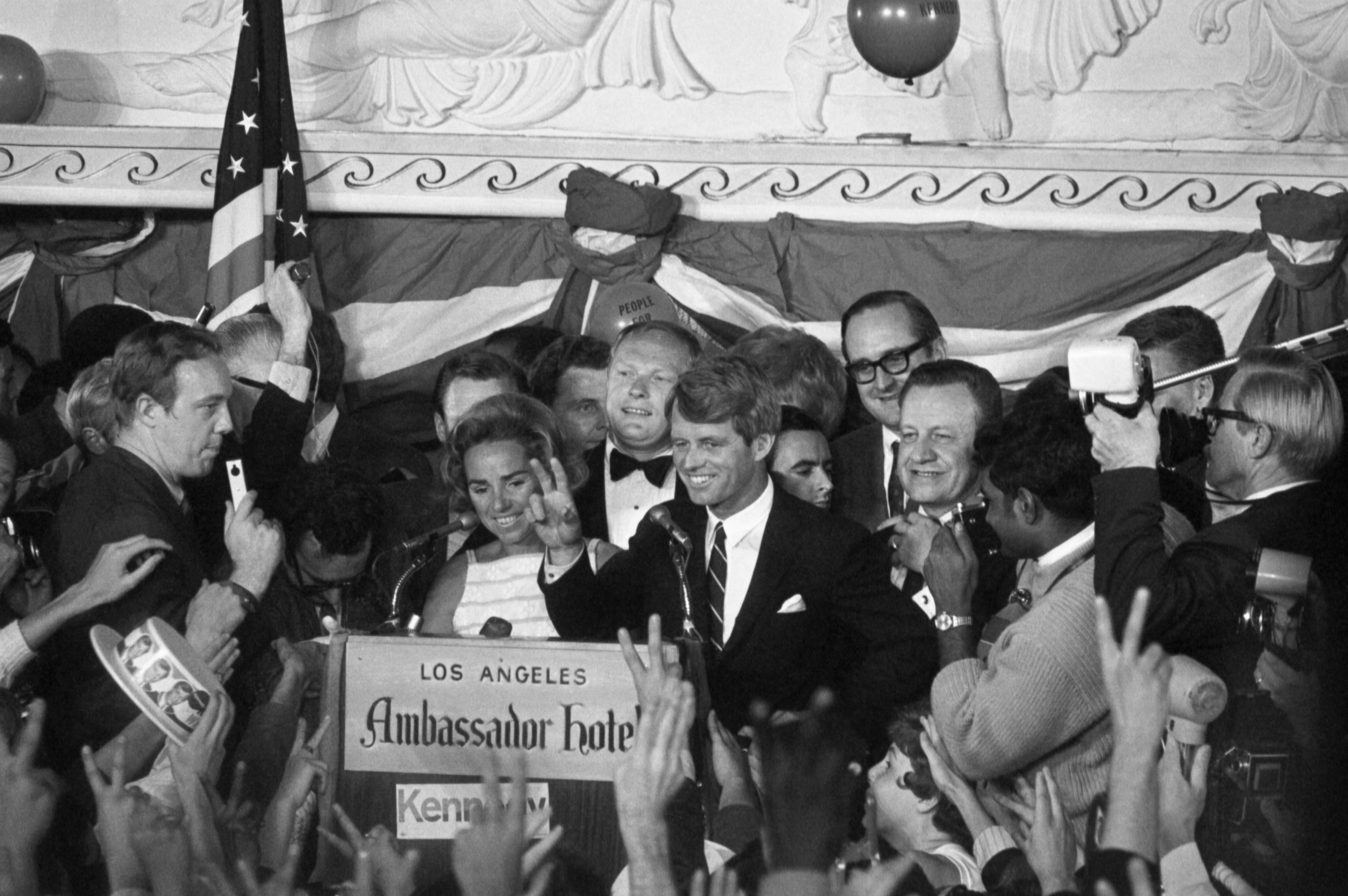 PHOTO: Sen. Robert Kennedy gives a  victory sign to a crowd at the Ambassador Hotel June 5, 1968, after winning the California primary. A few minutes later, he was brought down by an assassin's bullets upon entering a hotel corridor. 