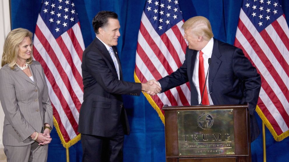 Republican presidential candidate Mitt Romney, center, shakes hands with Donald Trump after Trump endorsed Romney's presidential bid Feb. 2, 2012, at the Trump International Hotel in Las Vegas. Romney's wife, Ann.