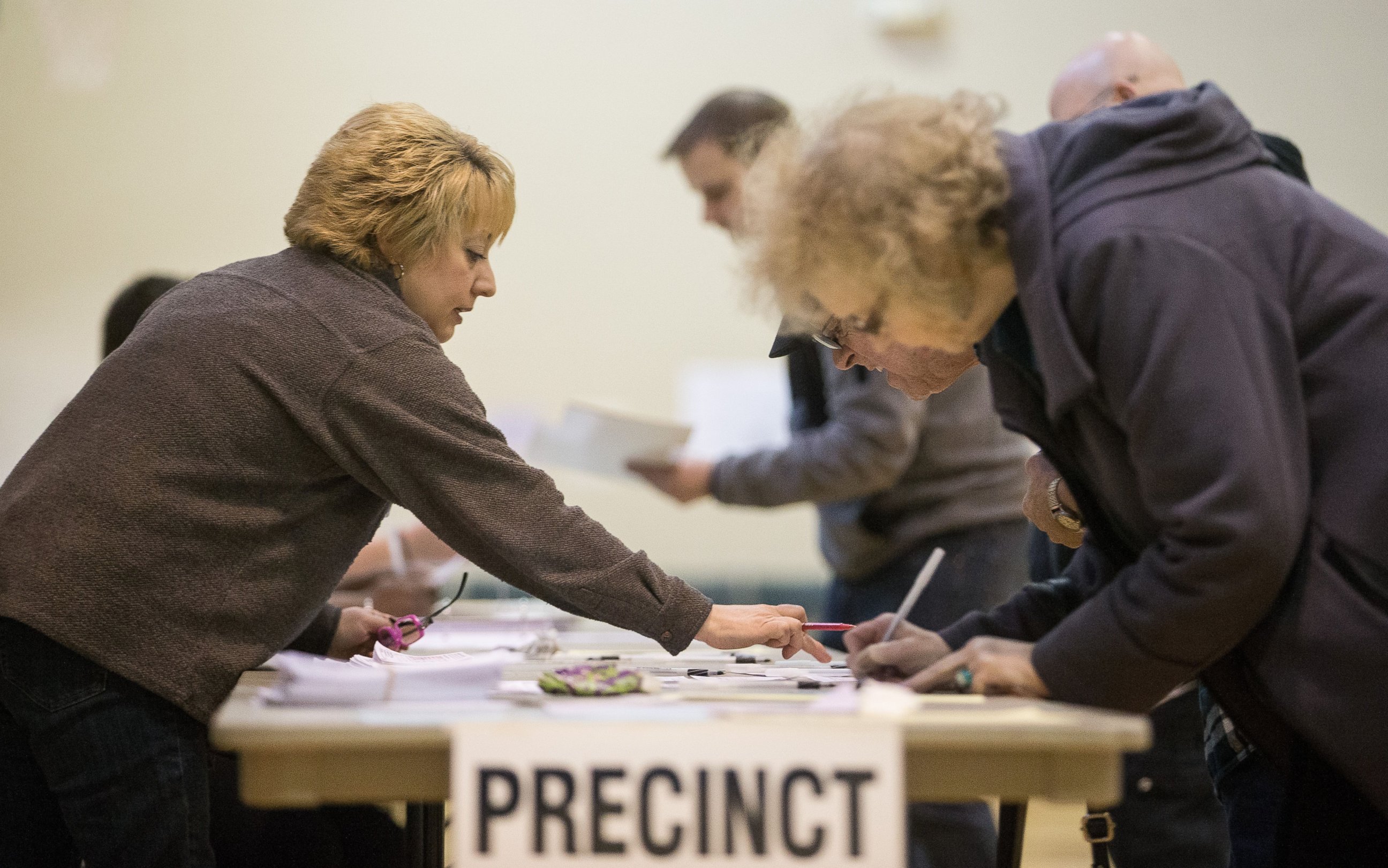 PHOTO: A poll worker instructs voters at a polling station in Warren, Mich., March 8, 2016. 