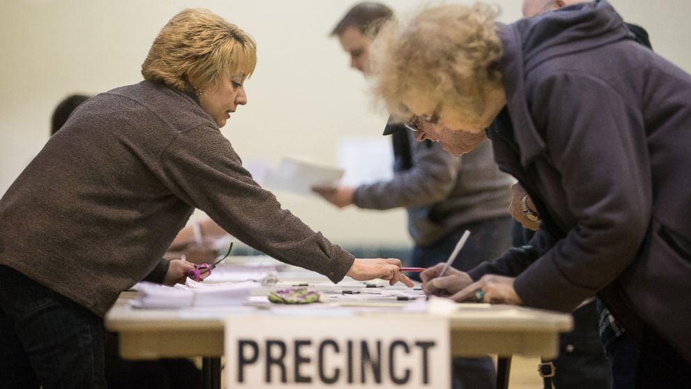 PHOTO: A poll worker instructs voters at a polling station in Warren, Mich., March 8, 2016. 