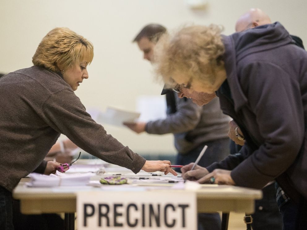 PHOTO: A poll worker instructs voters at a polling station in Warren, Mich., March 8, 2016.
