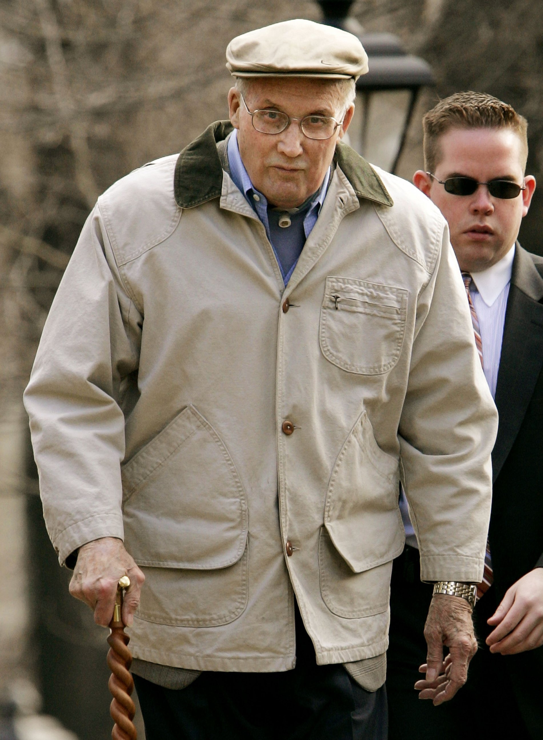 PHOTO: William Rehnquist leaves his house March 21, 2005 in Arlington, Virginia with a member of his security detail. 