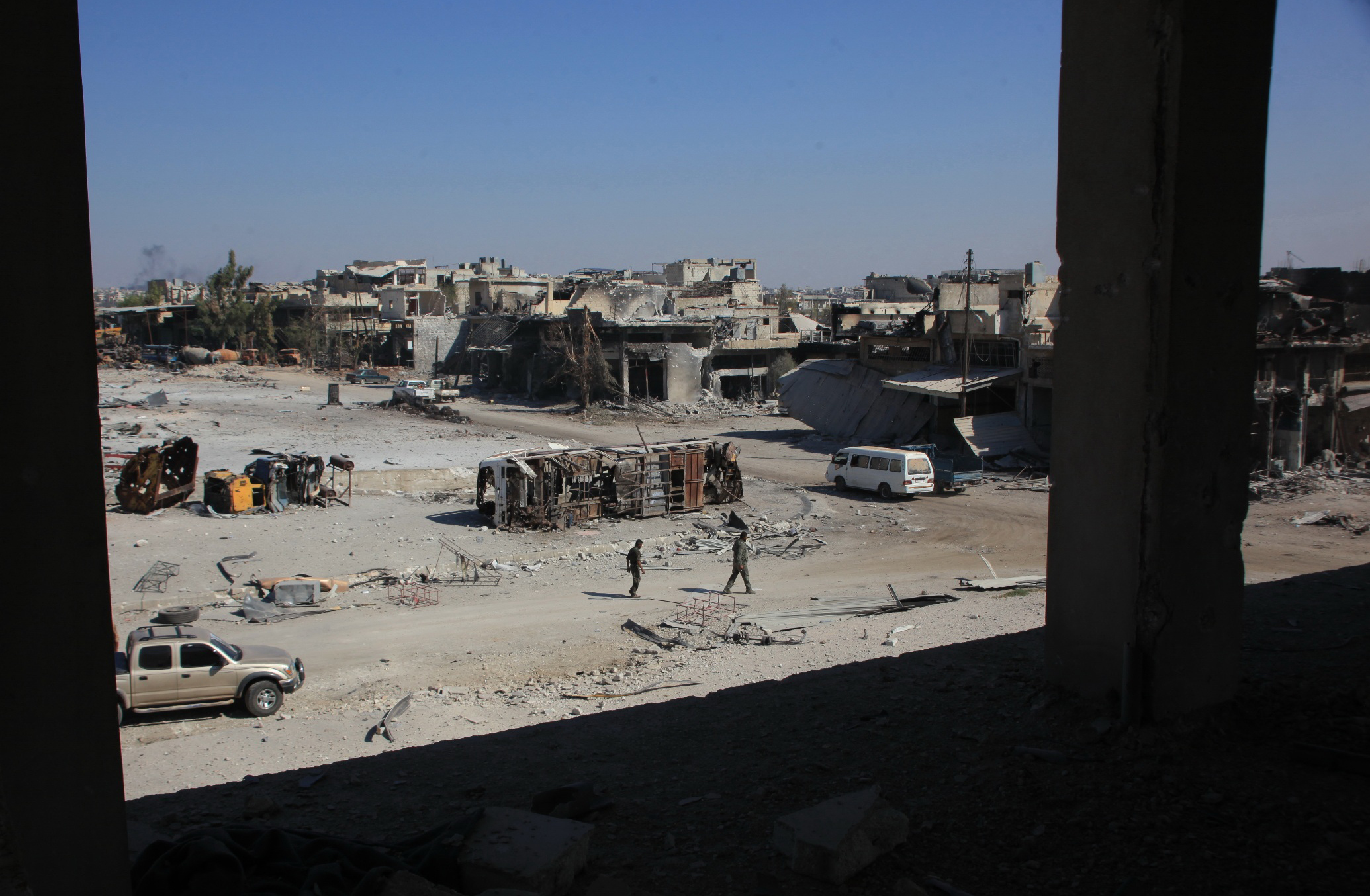 PHOTO: Syrian pro-regime fighters walk in a bombed-out steet in Ramussa on Sept. 9, 2016, after they took control of the strategically important district on the outskirts of the Syrian city of Aleppo the previous day. 