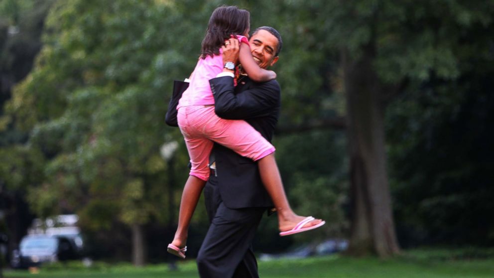 President Barack Obama is welcomed home by daughter Sasha on the South lawn of the White House in Washington, Sept. 15, 2009. 