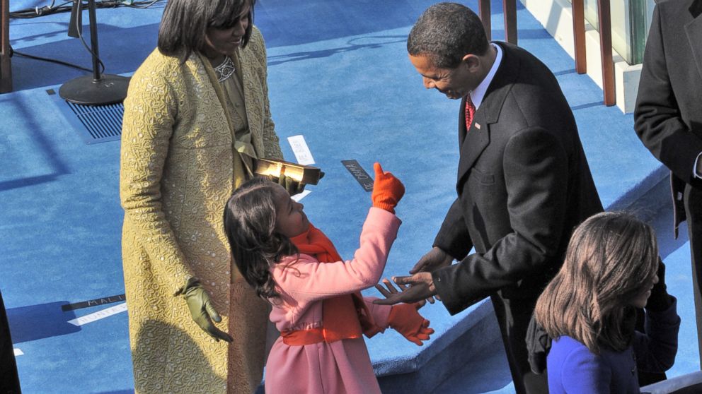 PHOTO: Sasha Obama gives her father a thumb's up after he takes the oath of office, Jan. 20, 2009. Her mother, Michelle, is at left and her sister, Malia, is at right. 