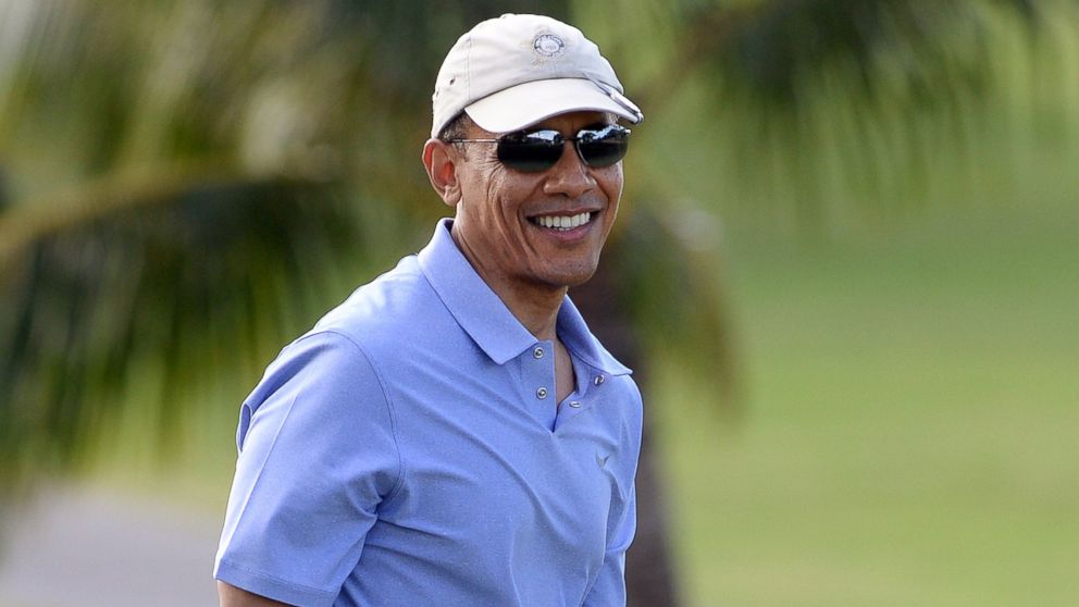 President Barack Obama smiles as he plays golf at Mid-Pacific Country Club in Kailua, Hawaii, Dec. 23, 2013. 