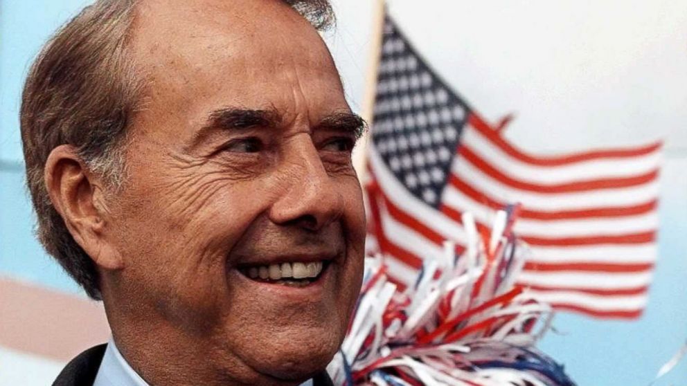 In this file photo, former Republican presidential candidate Bob Dole waits to be introduced at a campaign rally in Findlay, Ohio, Oct.11, 1996.