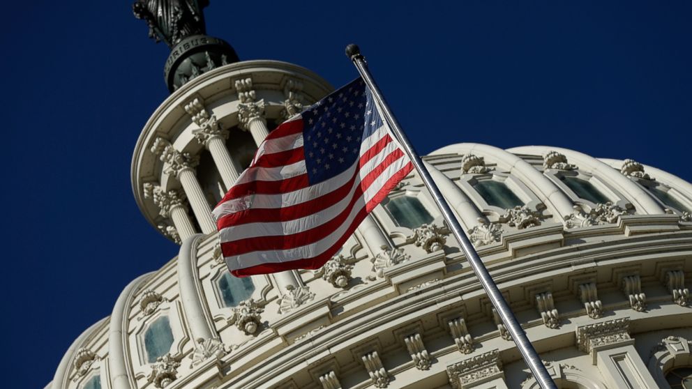An American flag waves outside the United States Capitol building as Congress remains gridlocked over legislation to continue funding the federal government Sept. 29, 2013 in Washington. 