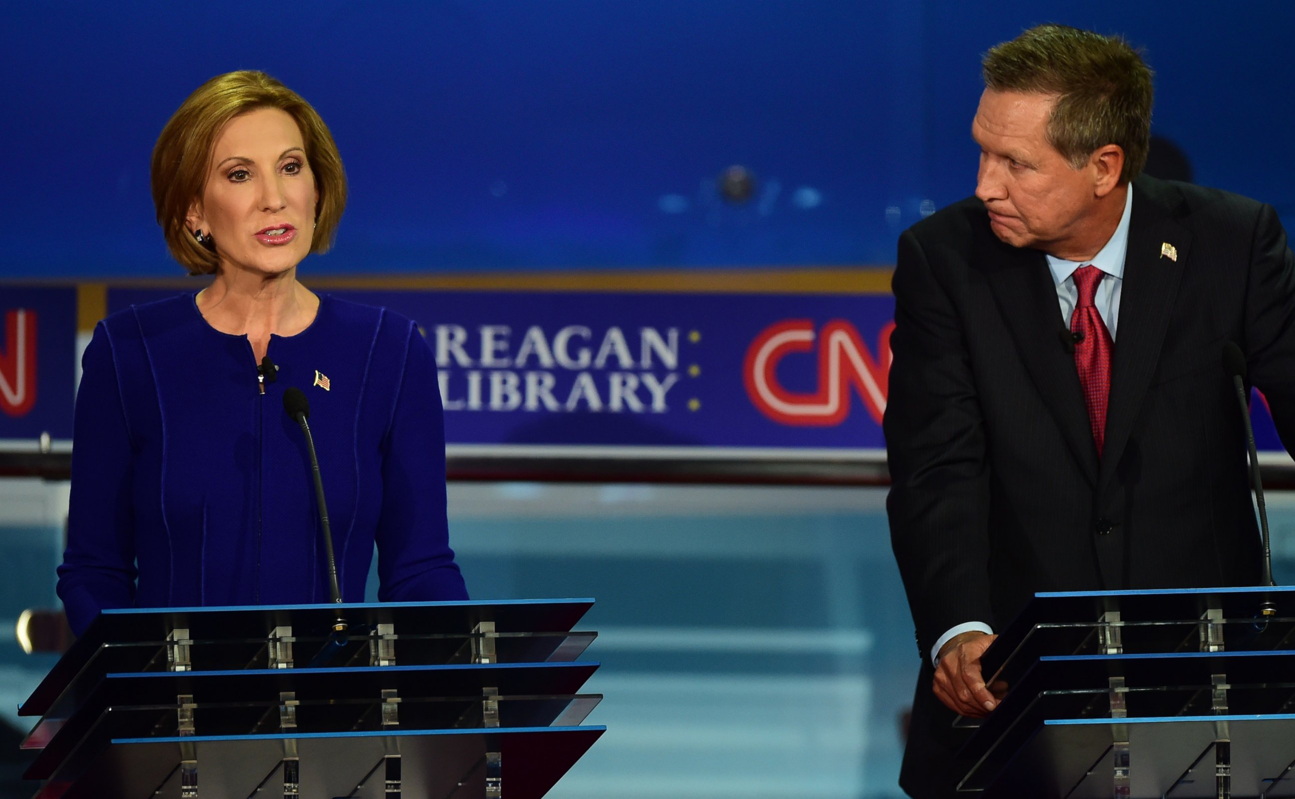 PHOTO:John Kasich looks on as Carly Fiorina, speaks during the Presidential debate at the Ronald Reagan Presidential Library in Simi Valley, Calif., Sept. 16, 2015. 