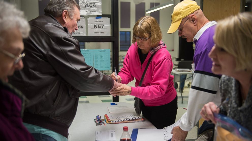 PHOTO: Caucus workers check-in voters prior the Republican Party Caucus at Keokuk High School, Feb, 1, 2016 in Keokuk, Iowa. 