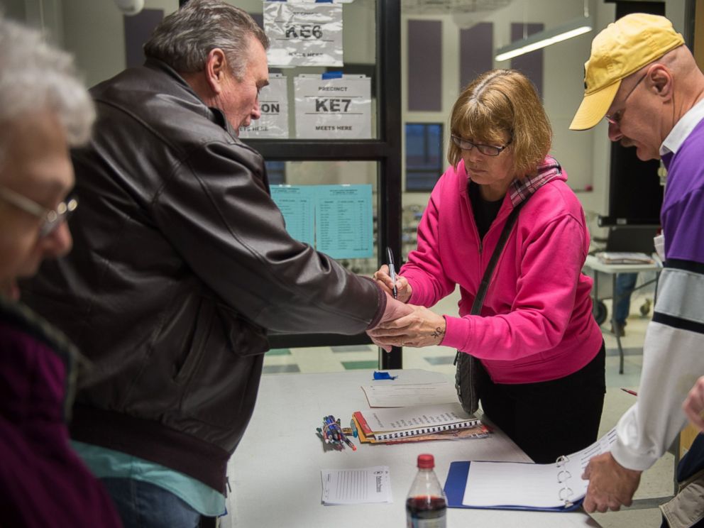 PHOTO: Caucus workers check-in voters prior the Republican Party Caucus at Keokuk High School, Feb, 1, 2016 in Keokuk, Iowa.